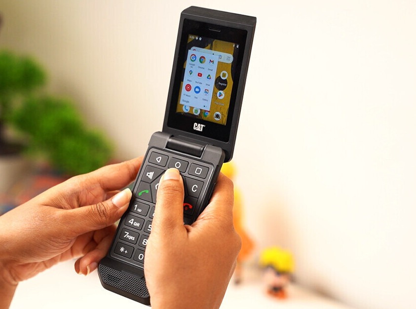 Person texting on a CAT S22 Flip with TyNi T9 Keyboard
